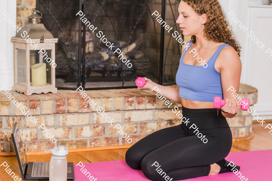 A young lady working out at home stock photo with image ID: 63cad894-1d7b-493e-8c5b-4b3c3969104a