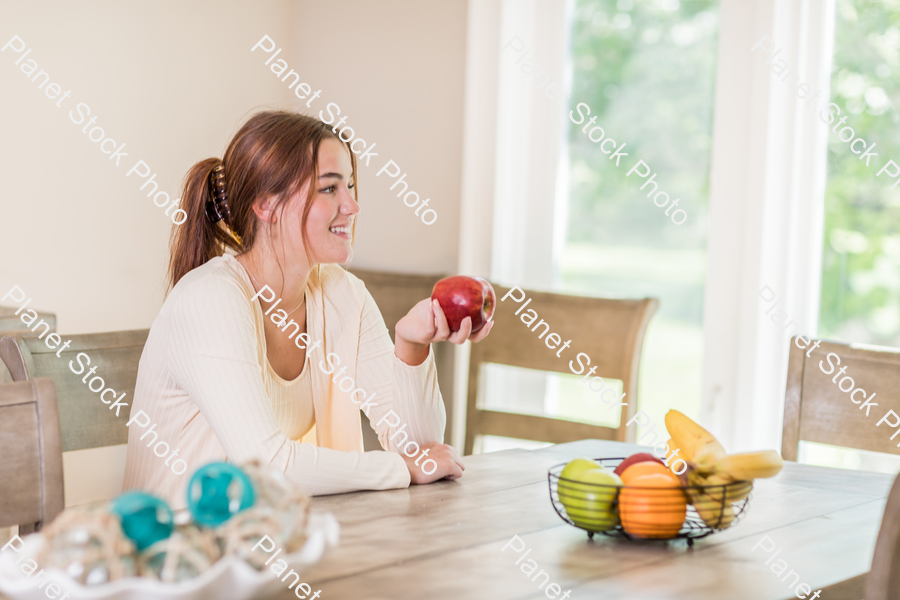 A young lady grabbing fruit stock photo with image ID: 64c9bf09-1755-4d76-a1ca-4a0ea5682d4d