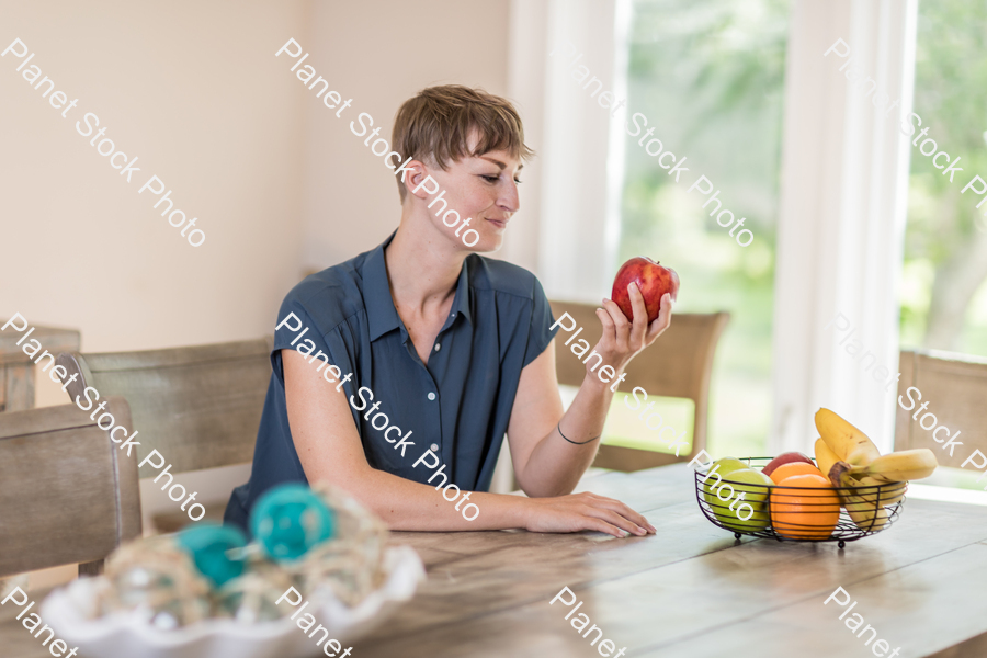 A young lady grabbing fruit stock photo with image ID: 653b54a2-c0c1-458f-af77-55ff3fcb1837