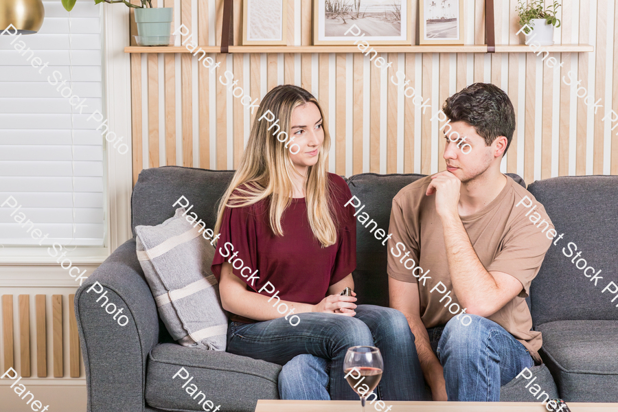 A young couple cozying up on the couch stock photo with image ID: 656385e2-02e4-4ac4-9ecc-2d1fcbb52e6a