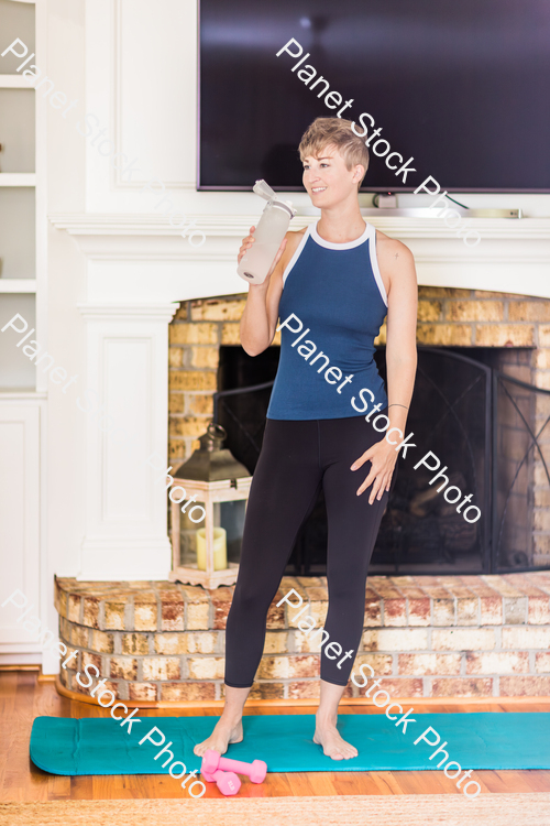 A young lady working out at home stock photo with image ID: 65d2c3eb-184b-4054-94af-fd7d2720427c