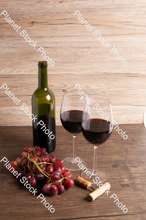 One bottle of red wine, with wine glasses, corkscrew, and grapes stock photo with image ID: 687c7698-7baa-4f48-be8b-08de623bafc7