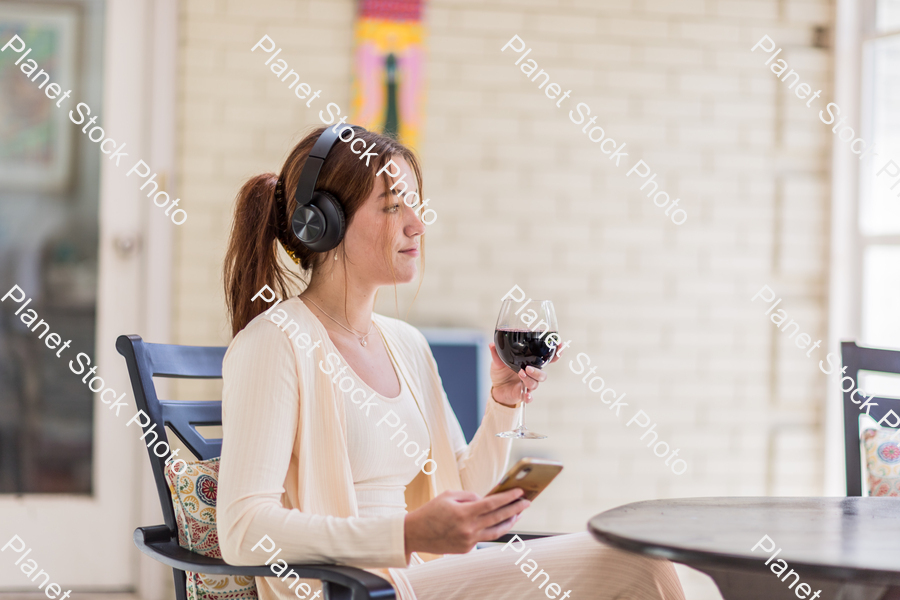 A young lady enjoying daylight at home stock photo with image ID: 6a104cba-e936-430c-85d8-6e7c25264d40