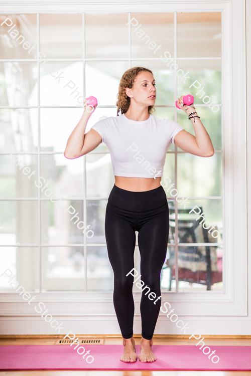 A young lady working out at home stock photo with image ID: 6b3f7102-6a55-418e-b532-137ef4b1ad02