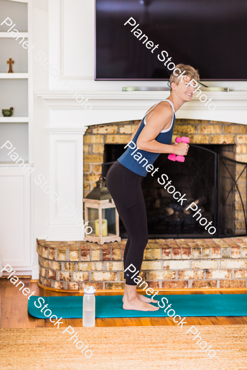 A young lady working out at home stock photo with image ID: 6b46f42e-8b05-46b8-a1ff-f4238e676247