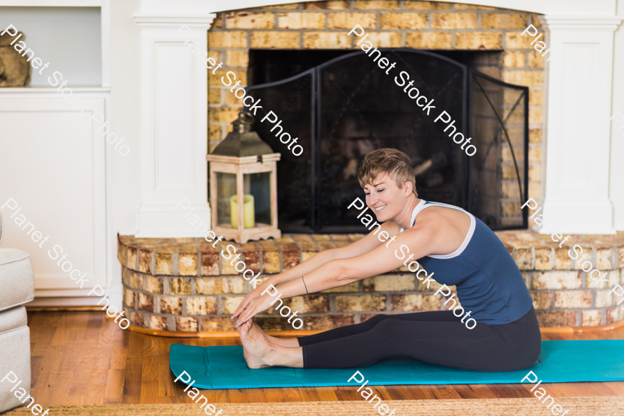 A young lady working out at home stock photo with image ID: 6c679aa5-4d7b-4dff-a546-8543523267b4