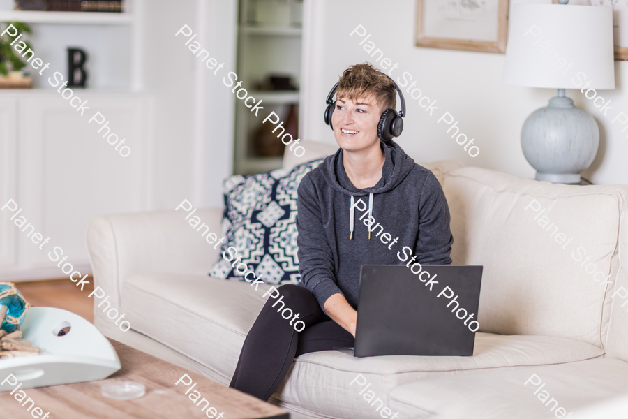 A young lady sitting on the couch stock photo with image ID: 6c78abbf-b3d6-4d19-8ee4-c2b79c807bf7