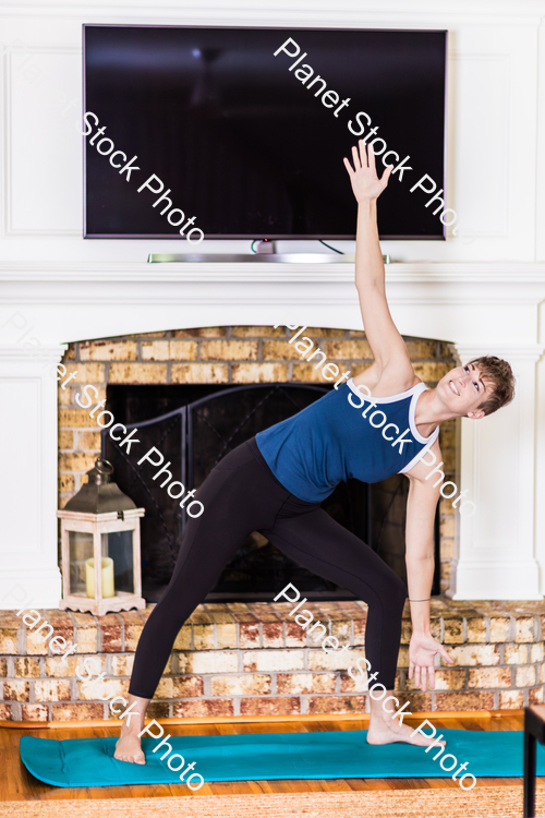 A young lady working out at home stock photo with image ID: 6c9d72dd-289a-48b5-9250-a35a73834056