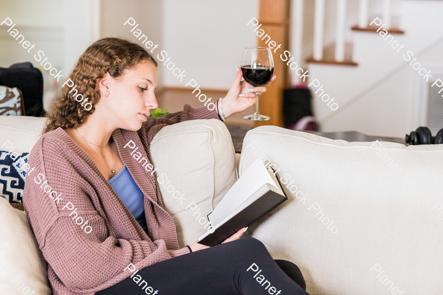 A young lady sitting on the couch stock photo with image ID: 6d4f57c7-db5c-418d-b8ed-082d7214bae9