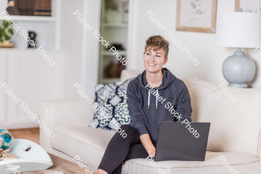 A young lady sitting on the couch stock photo with image ID: 6e09fae3-199c-4798-b762-a0269fbacf2a
