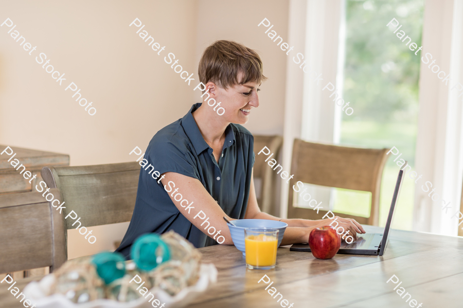 A young lady having a healthy breakfast stock photo with image ID: 7063bbd3-c302-419a-8914-ba840b7c8635