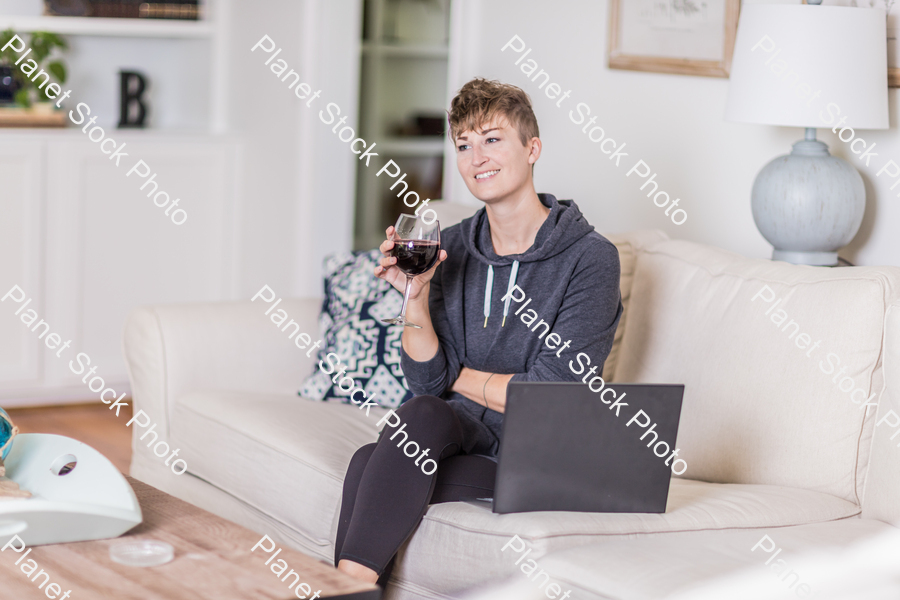 A young lady sitting on the couch stock photo with image ID: 70666380-4c70-4f37-bc3a-43044d209e5d