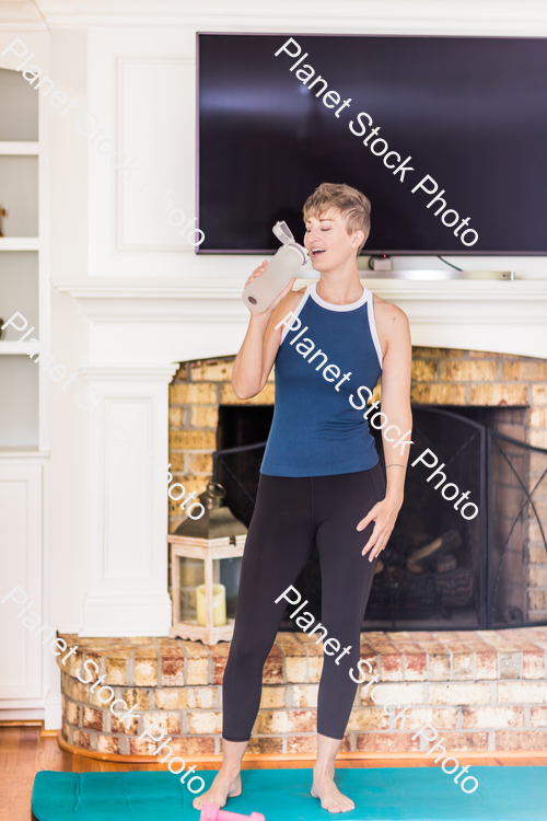 A young lady working out at home stock photo with image ID: 718d2140-0a5c-44a3-95fd-c4eb2b2bee79