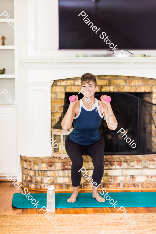 A young lady working out at home stock photo with image ID: 72194691-beca-4b40-8699-59a662fdf4a1