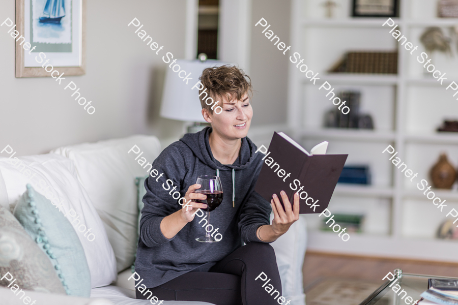 A young lady sitting on the couch stock photo with image ID: 721fe7fa-5548-4600-a144-241171796dde
