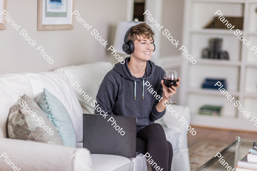 A young lady sitting on the couch stock photo with image ID: 733cca2e-855a-4144-8e9f-f97e7c19a5af