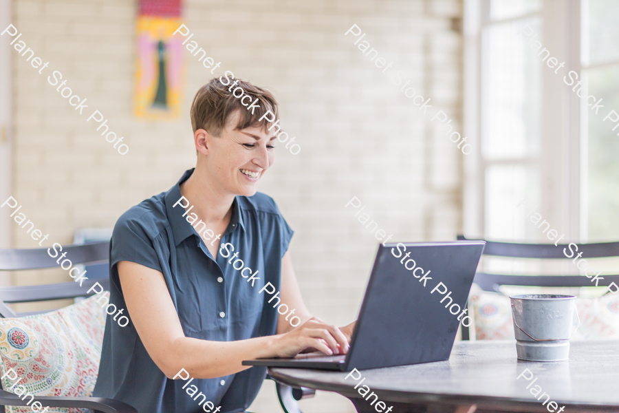 A young lady enjoying daylight at home stock photo with image ID: 73c10b88-1781-4f12-9433-c22b2d0d9540