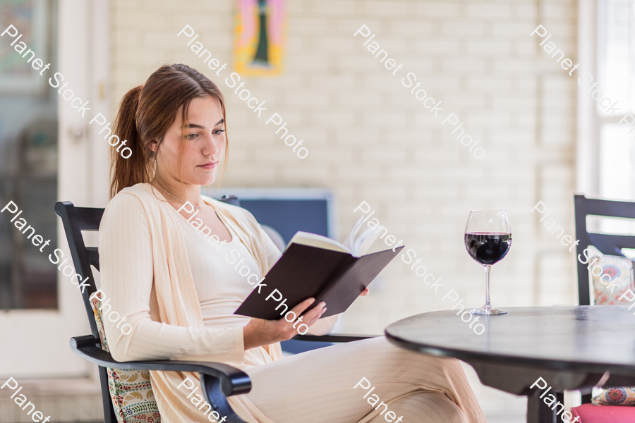 A young lady enjoying daylight at home stock photo with image ID: 74de3c5c-c822-4d8f-8637-ff2fd99ad784