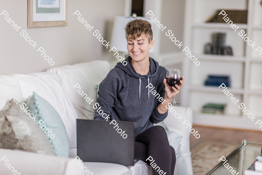 A young lady sitting on the couch stock photo with image ID: 767dc8de-da20-4cb0-931d-abc844d48e76