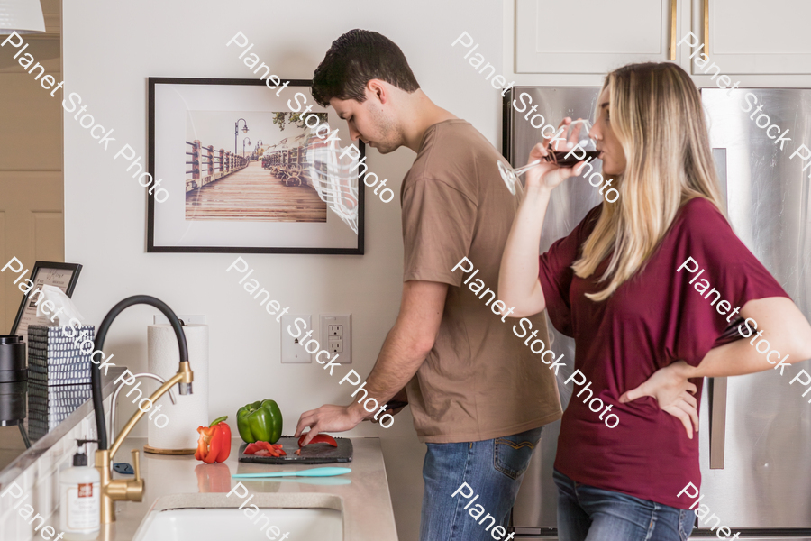 A young couple preparing a meal in the  kitchen stock photo with image ID: 77162b7b-ac4e-434a-ab0f-c12176805c69