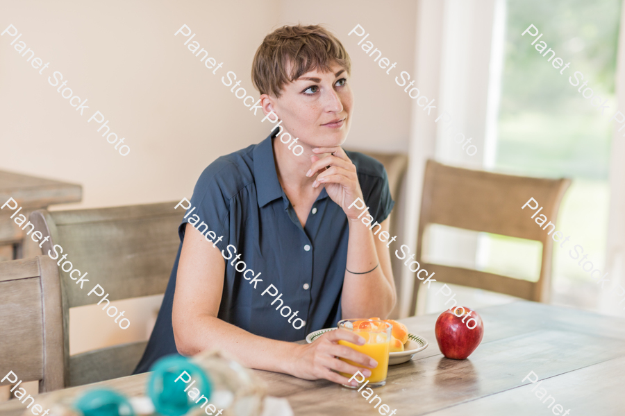 A young lady having a healthy breakfast stock photo with image ID: 7771a1cc-6e56-4393-86aa-5a026477de8a