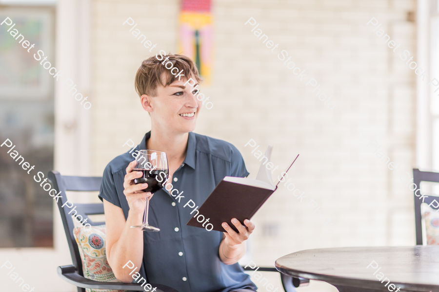 A young lady enjoying daylight at home stock photo with image ID: 77a516e7-3b02-4db7-a461-a5b0d1b3729d