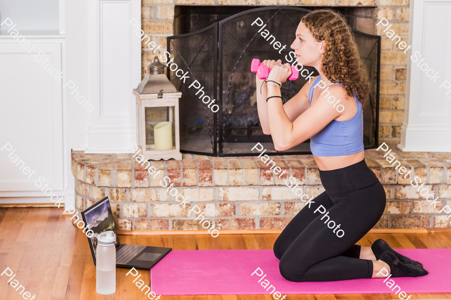 A young lady working out at home stock photo with image ID: 78316eb1-b5c5-4432-a8d6-63254fd5f262
