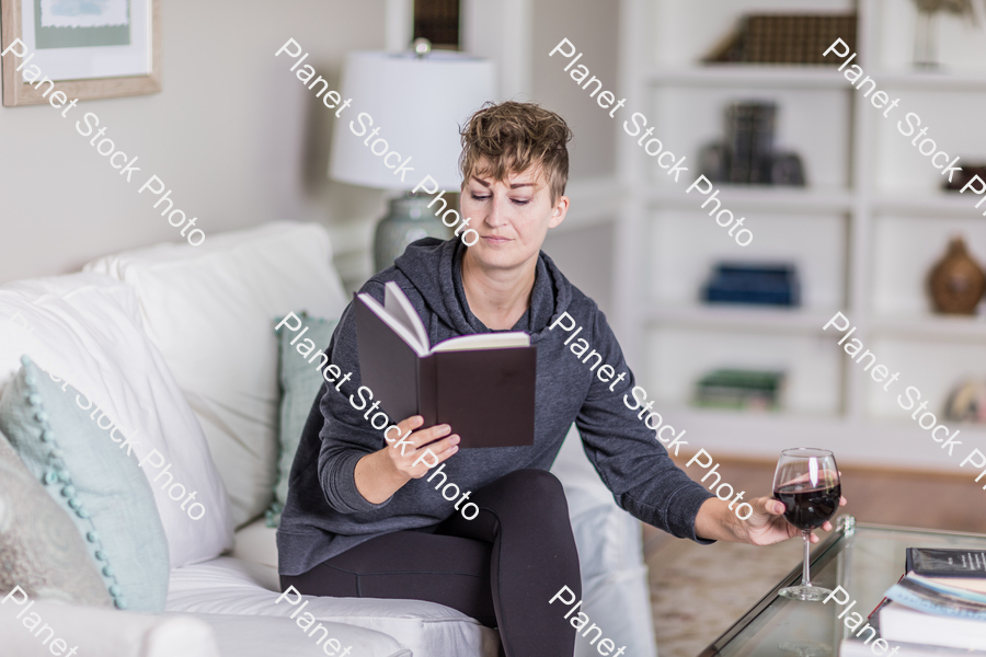A young lady sitting on the couch stock photo with image ID: 784d8cf9-c01f-41c7-8270-b732f75359c9