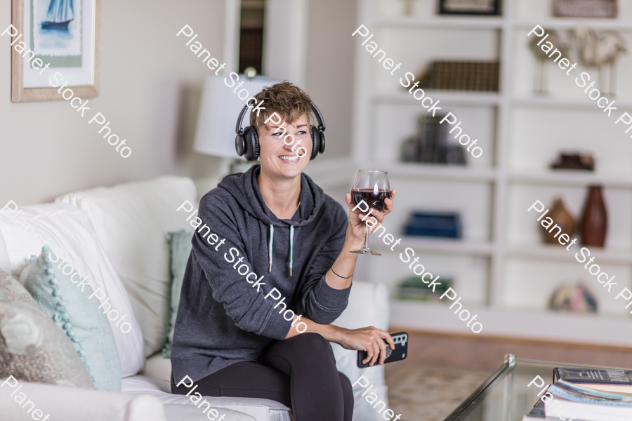 A young lady sitting on the couch stock photo with image ID: 78efbc60-3217-47bd-9091-3de3e3393d66