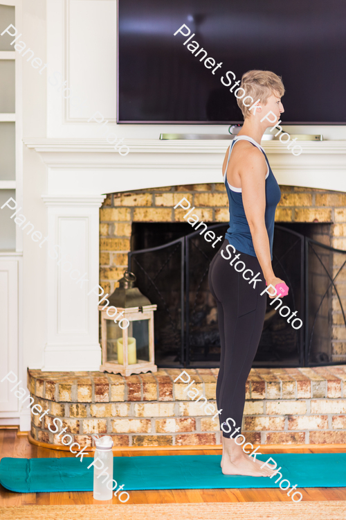 A young lady working out at home stock photo with image ID: 796cf7f5-9e41-436e-8bc2-5d32a4d59706