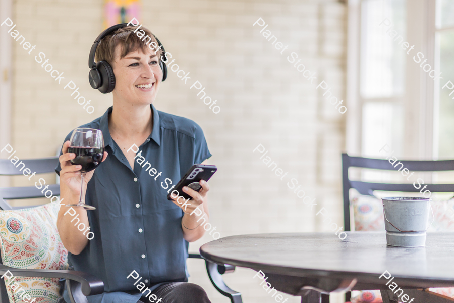 A young lady enjoying daylight at home stock photo with image ID: 7cd48c5e-6fb3-4543-8d7a-71996f701b59