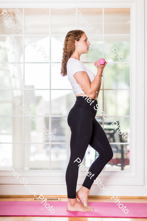 A young lady working out at home stock photo with image ID: 7db66a64-fba0-424f-93a9-da8cf841d450