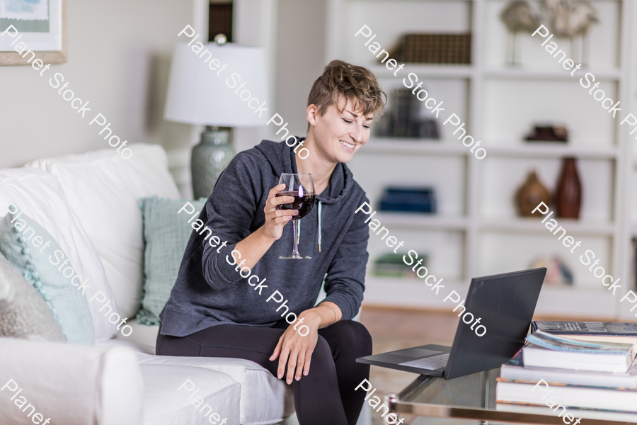 A young lady sitting on the couch stock photo with image ID: 7e09c64d-ded4-41d4-b310-df9fbeaf6d16