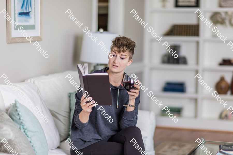 A young lady sitting on the couch stock photo with image ID: 7fb8e218-4ad4-4971-a831-5087dbdaf1d9