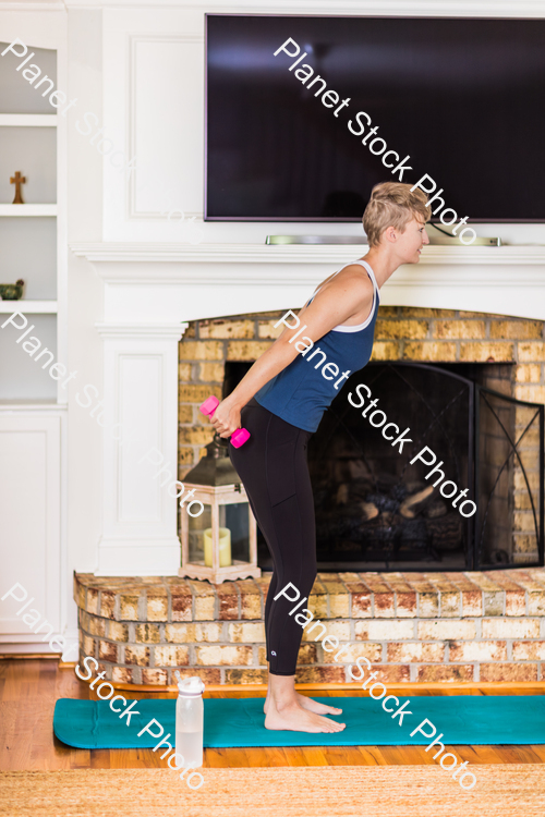 A young lady working out at home stock photo with image ID: 80cf5ae4-ec3f-4972-9722-692b4f059c69