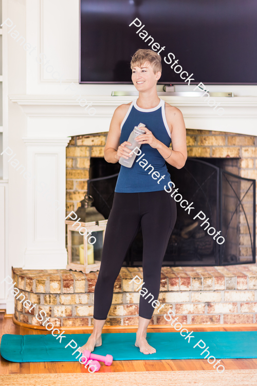 A young lady working out at home stock photo with image ID: 81dcf228-4fb8-429a-be3d-632224dcff06