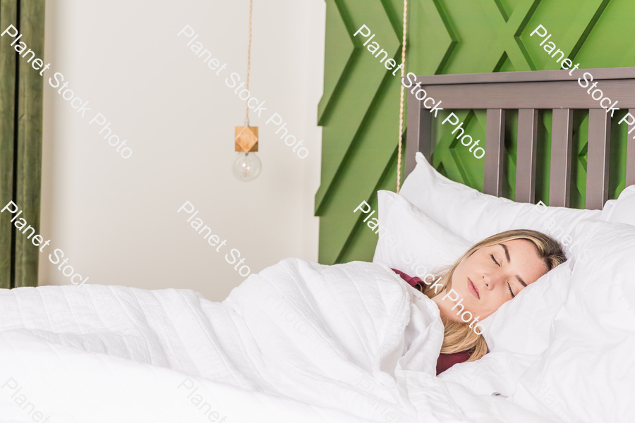 A young woman sleeping in bed stock photo with image ID: 840c417d-0ac5-4f40-94d8-3d4773151b2a