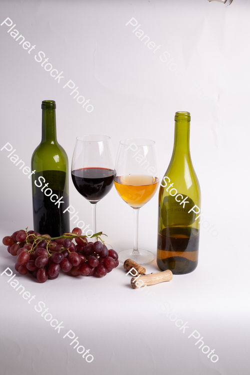 Two bottles of wine, with corkscrew, grapes, and wine glasses stock photo with image ID: 88e06fbb-849d-446c-a742-c57554dcb062