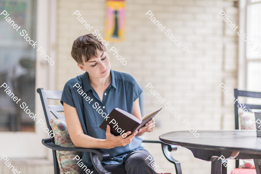 A young lady enjoying daylight at home stock photo with image ID: 8a9f2a34-02e2-4751-afa5-4498fa9509db