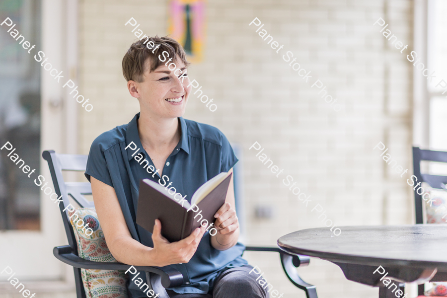 A young lady enjoying daylight at home stock photo with image ID: 8c39723f-6471-4cfd-93c3-0d9c292d31b9