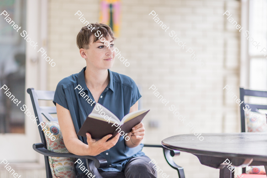 A young lady enjoying daylight at home stock photo with image ID: 8ed71846-4f7e-4fc8-81a0-fc94f249e069