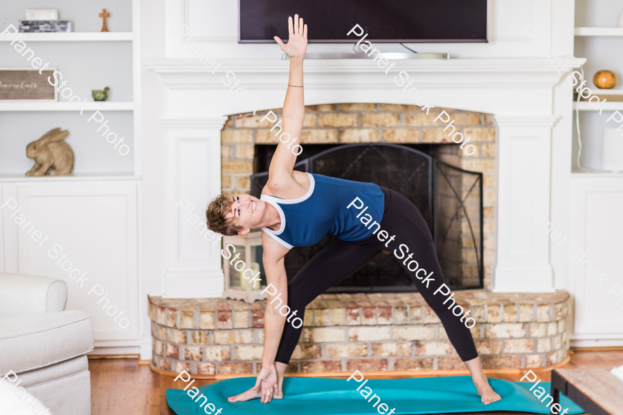 A young lady working out at home stock photo with image ID: 9136d598-2cab-4246-b69d-09ec807bcfda
