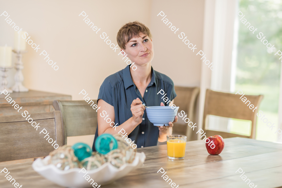 A young lady having a healthy breakfast stock photo with image ID: 913eb98e-384d-4ee3-a627-ed140c3da270