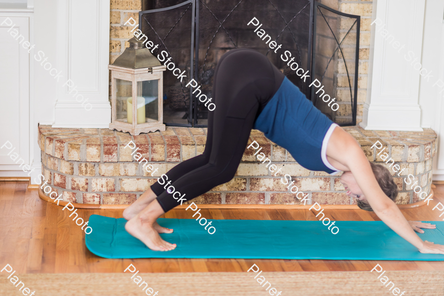 A young lady working out at home stock photo with image ID: 91bab18d-5fb6-402e-8dc1-19ec66f7cbfb