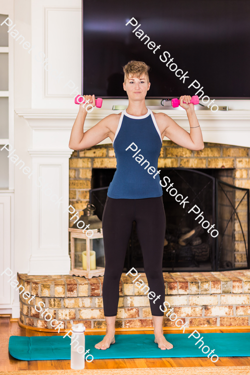 A young lady working out at home stock photo with image ID: 91bf1a68-01a3-4b88-9733-5b5244d85233