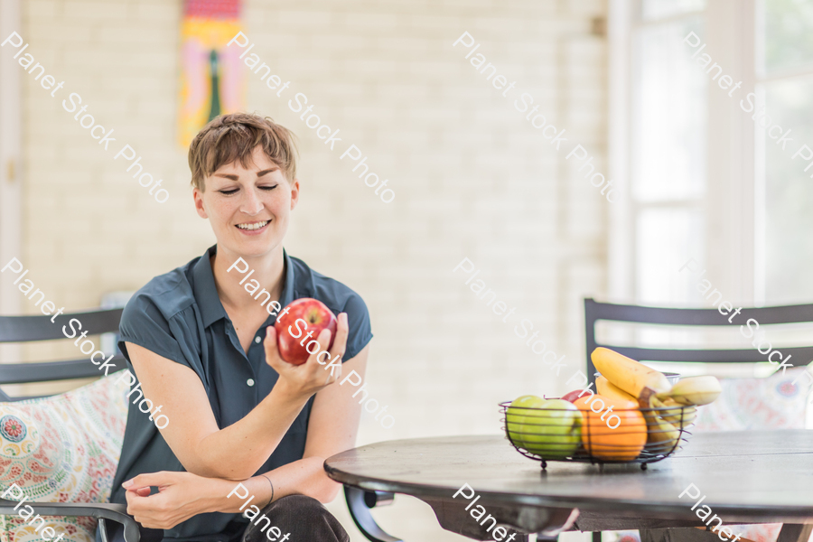 A young lady enjoying daylight at home stock photo with image ID: 93a0002f-09b1-43e8-9e4e-49a9c127d554