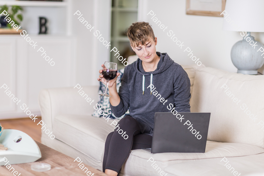 A young lady sitting on the couch stock photo with image ID: 944a22a8-6931-4a1b-9d79-57eb48784380