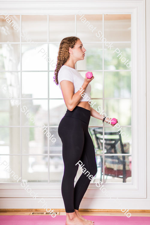 A young lady working out at home stock photo with image ID: 9643ea99-30b8-4d9a-b321-2aba80bf6933