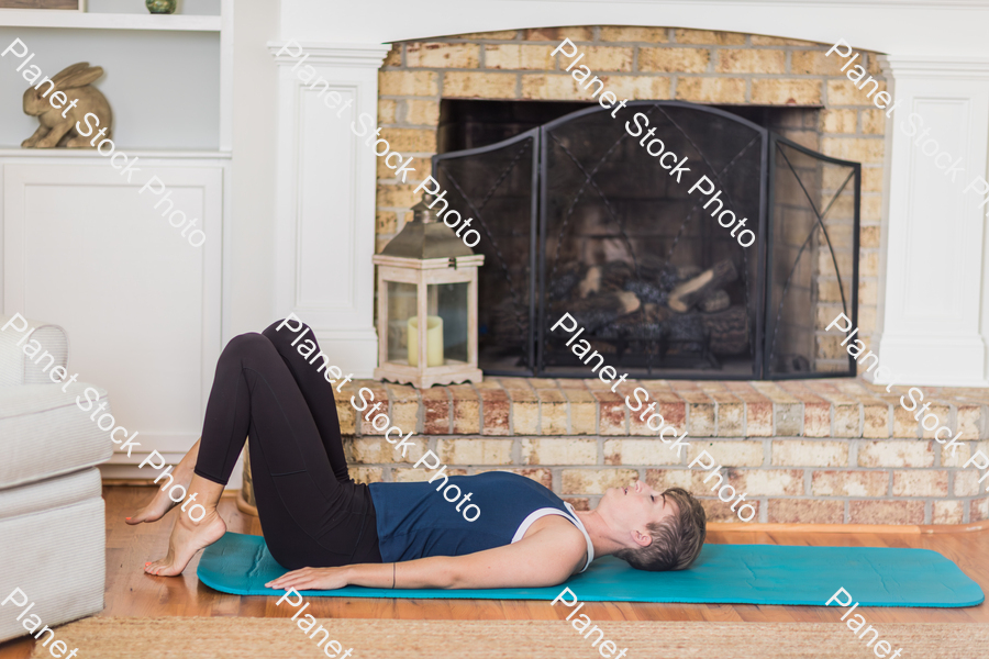 A young lady working out at home stock photo with image ID: 98237133-6d35-4bb0-aeea-f33b99225e68