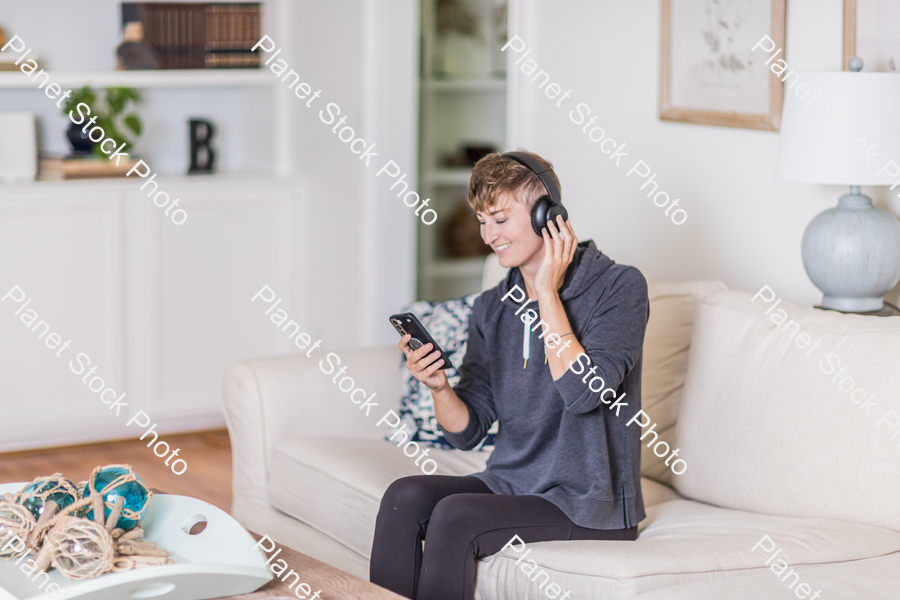 A young lady sitting on the couch stock photo with image ID: 993bcbe9-637c-473a-8ab8-97e65844f51f